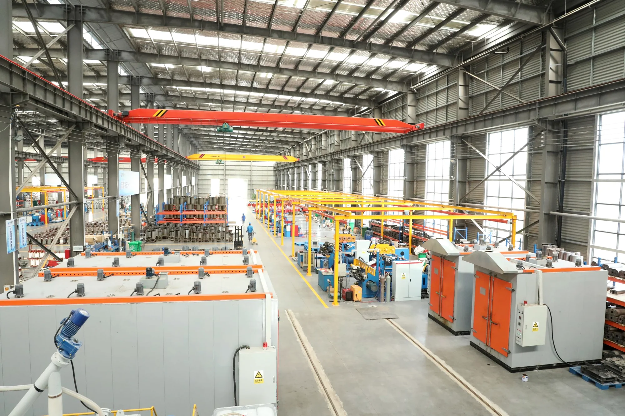 Production workshop with electrical equipment assembly lines and overhead cranes