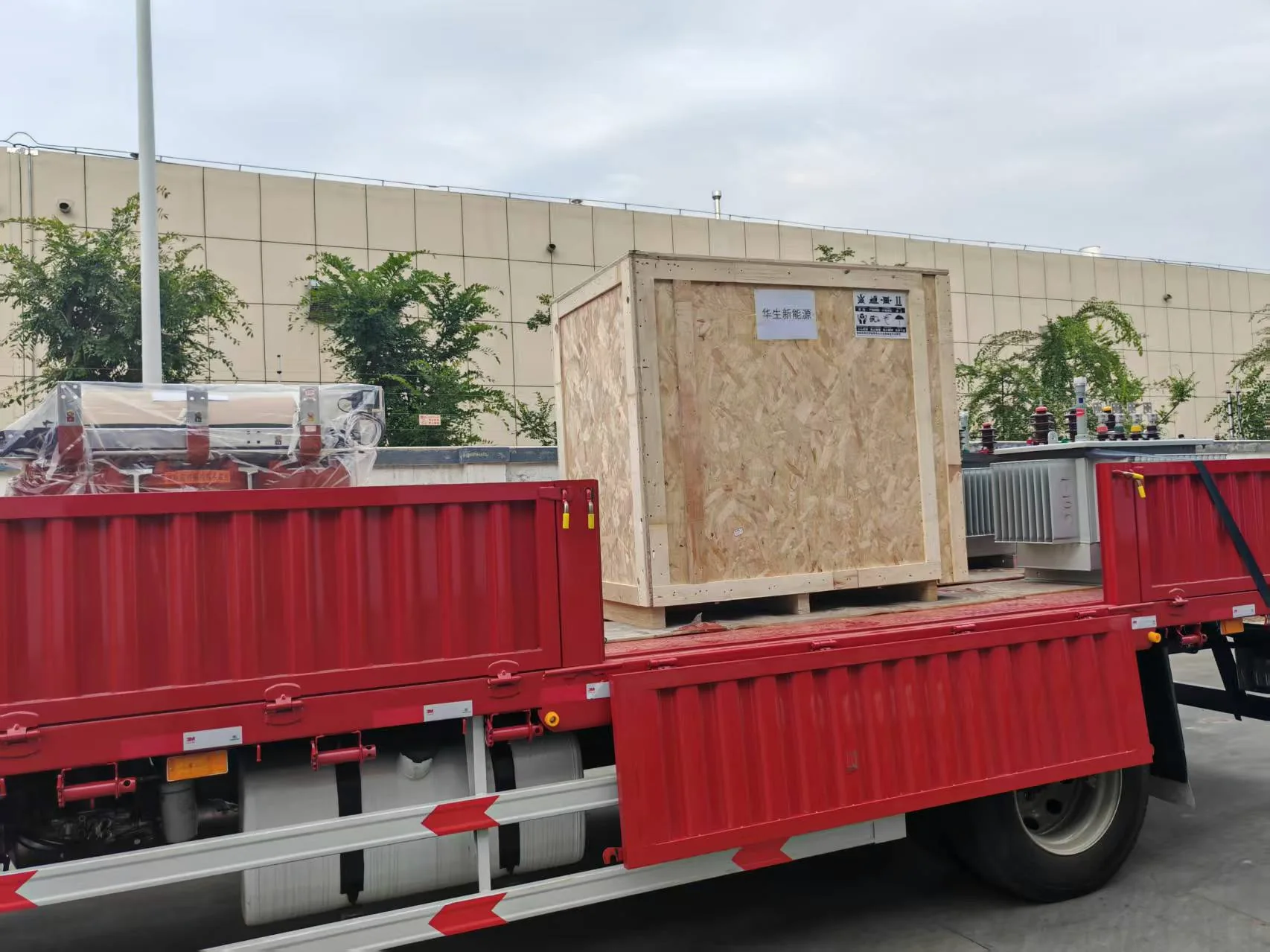 Wooden crate and transformer equipment loaded on a truck.